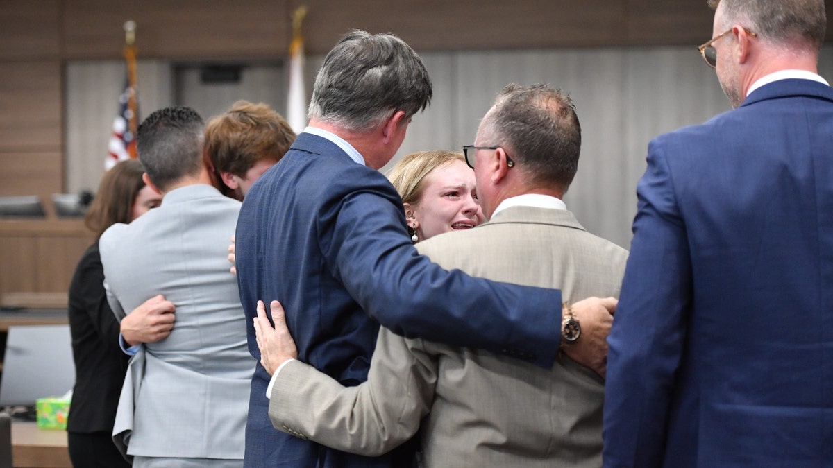Maya Kowalski huilt terwijl ze haar advocaten omhelst aan het einde van haar proces